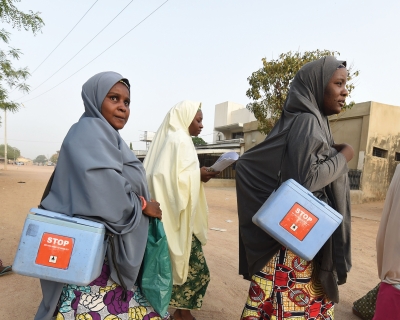 Health workers walk from house to house during a polio vaccination campaign in Hotoro-Kudu, Nassarawa district of Kano, Nigeria. April 22, 2017.  Pius Utomi Ekpei/AFP via Getty Images