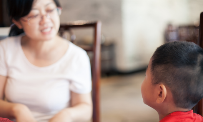 A woman and young boy speaking to each other 