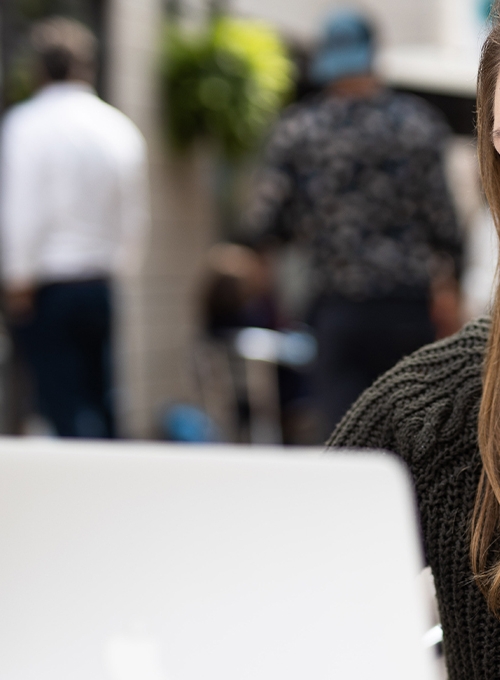 A female BSPH student on a laptop attending a virtual chat session