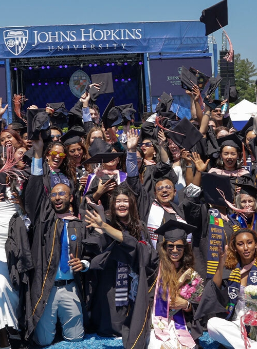 Group photo of graduates at the 2024 Bloomberg School convocation on Homewood Field