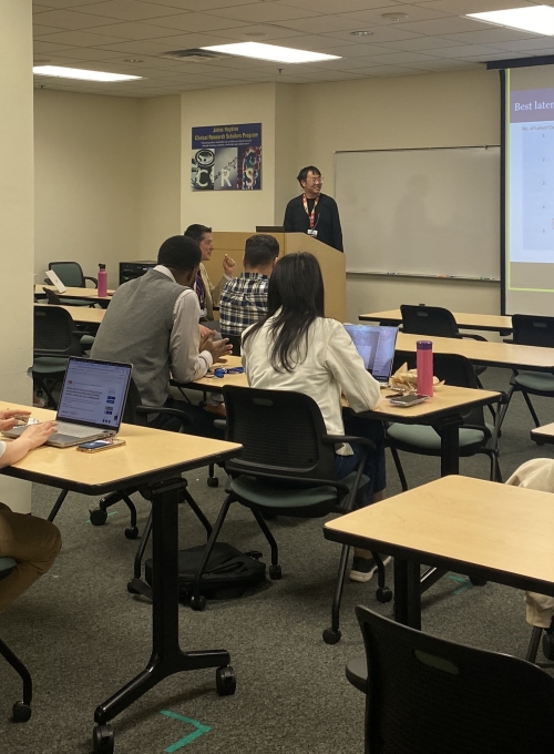 Attendees listen during a Research in Progress meeting in 2024.