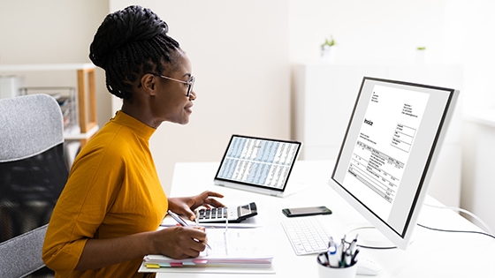 woman working at her desk using her computer