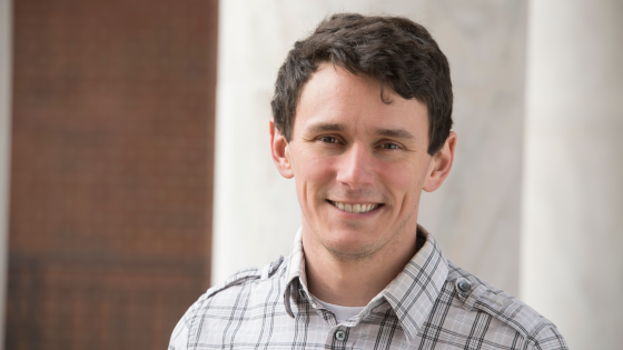 Scot Miller man smiling standing in front of building