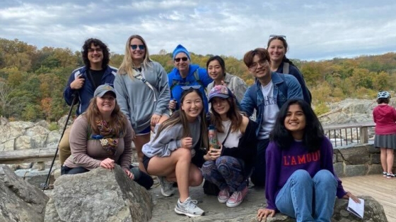 eheso-hike-2 group of students pose on a rock with a natural background