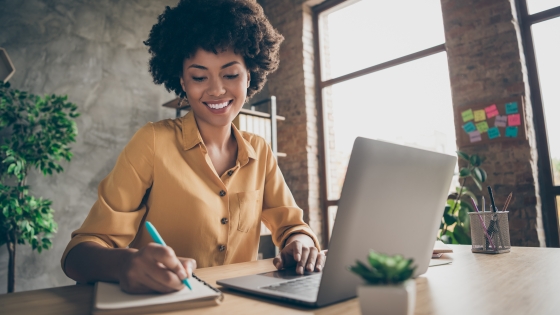 woman siting as a desk with a laptop