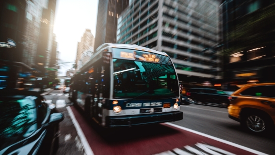 Bus approaching in bus lane on busy city street