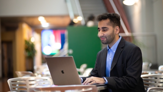 A student works on a computer at a table 