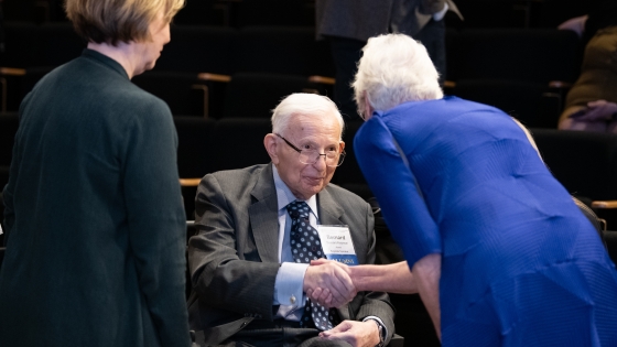 Keynote Speaker Bernard Roizman is greeted by Bloomberg School Dean Ellen MacKenzie