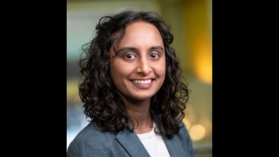 A headshot of a woman wearing a suit jacket as she smiles