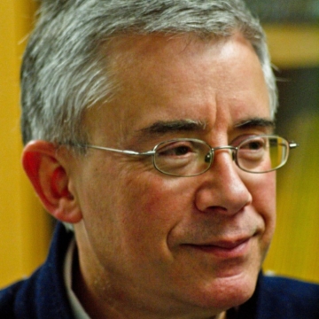 close up of man wearing glasses looking away from camera