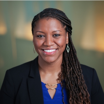 A woman with braided hair smiling