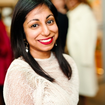 Portrait of South Asian woman with long black hair and white top