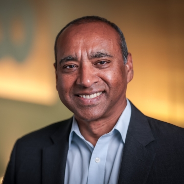 EHE Shyam Biswal head shot of a man in a blue shirt and suit jacket