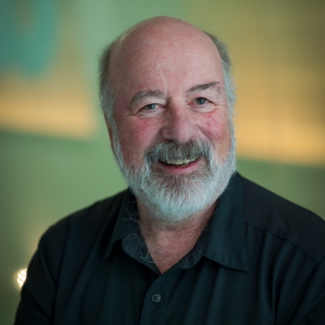 head shot of man in a black shirt