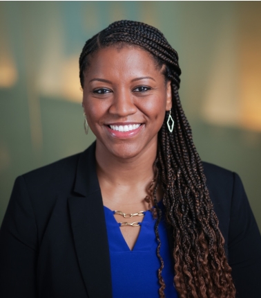 A woman with braided hair smiling