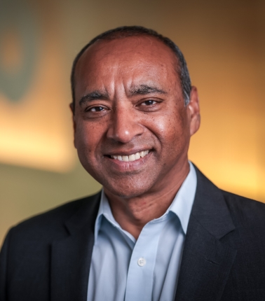 EHE Shyam Biswal head shot of a man in a blue shirt and suit jacket
