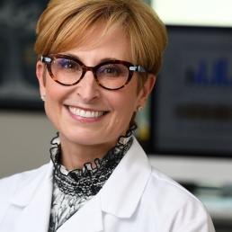 Photo of Sabra Klein in a white lab coat