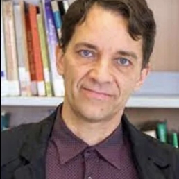 Portrait of man standing in front of books