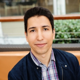 Photo of young man outdoors on college campus 