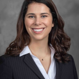 A headshot of Sarah Jabour wearing a blazer with an open tooth smile 