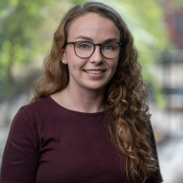 image of Anya O'Neal in crimson sweater with blurred background