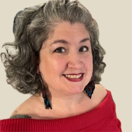 A headshot of a smiling woman