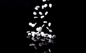 Ketamine pills fall onto a table. 