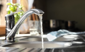 photo of a kitchen faucet with water running