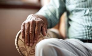 image of an elderly man sitting in a chair 