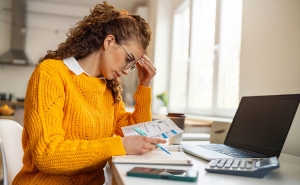 Woman at desk looking frustrated.