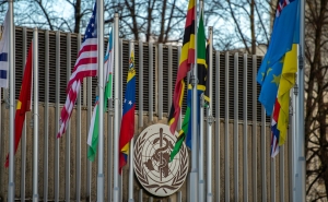 Outside the W.H.O.'s Geneva headquarters, flag poles flying flags of member states, including the U.S.