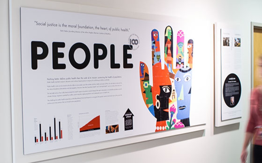 A woman walks by a Centennial art feature focused on People A woman walks by a Centennial art feature focused on People