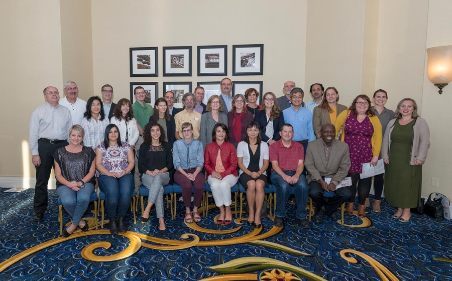 Over two dozen BMB alumni sit and stand in three rows
