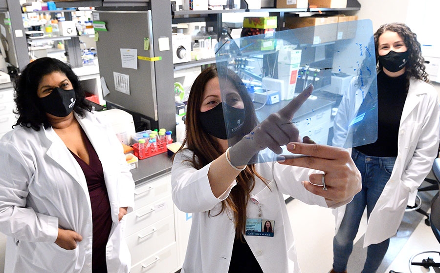 Faculty and students in a lab.
