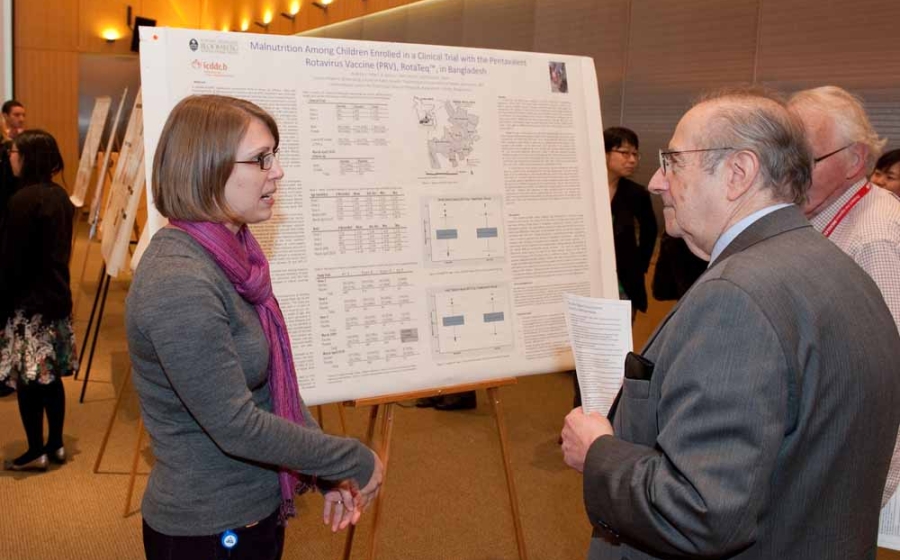 Photo of PhD student Andrea Feller discussing her research with Dr. Plotkin
