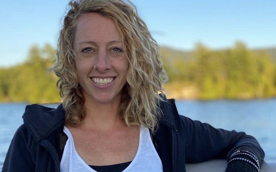 PhD candidate Jennifer O'Keeffe Jennifer O'Keeffe stands lakeside, with a beautiful blue sky behind her.