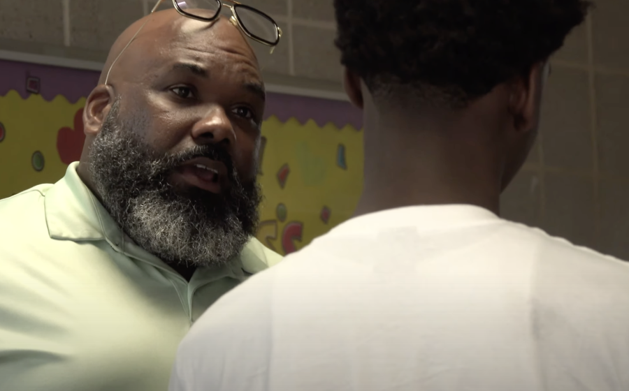 Jayson Green with Student at New Song Community Learning Center. 