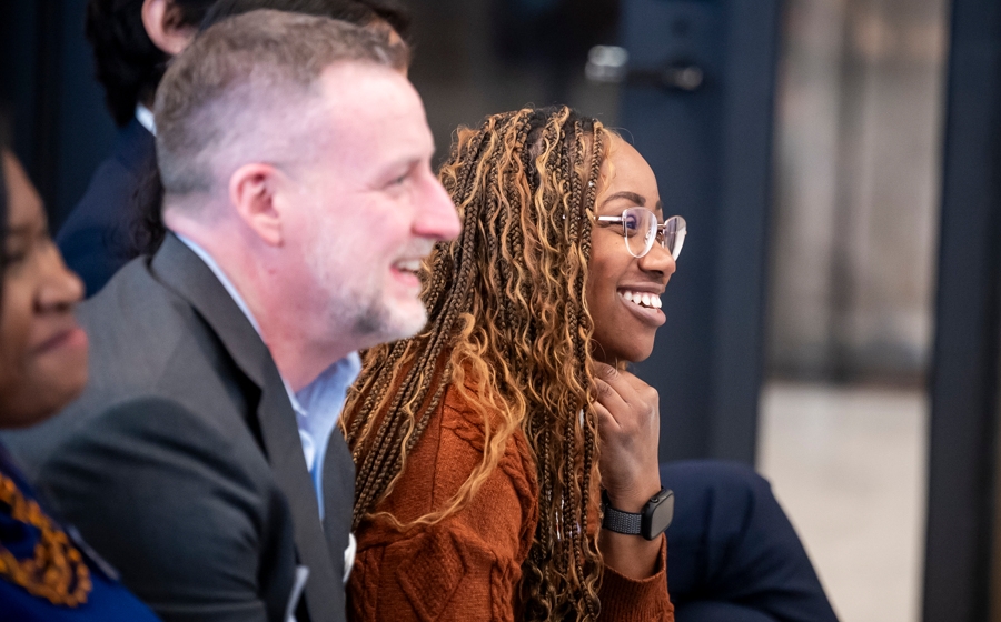 Two audience members are laughing.