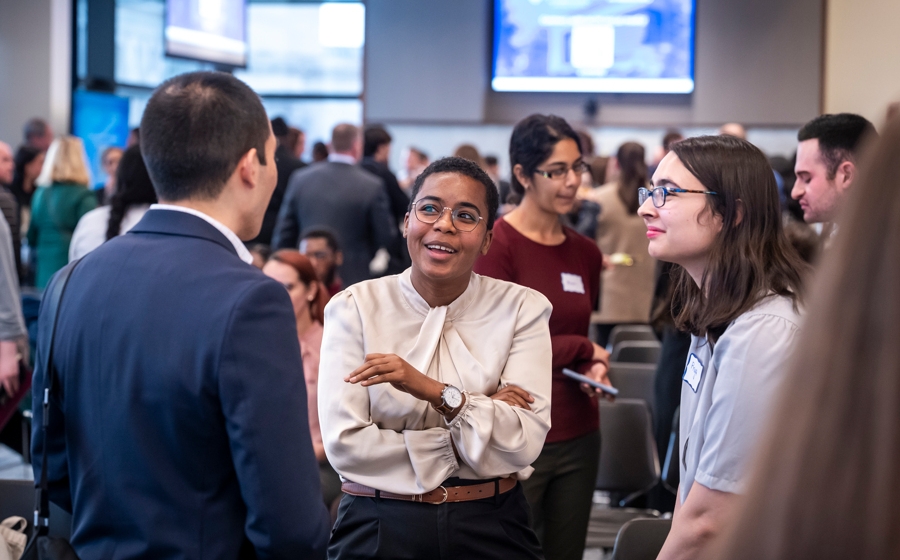 Members of event crowd socialize.