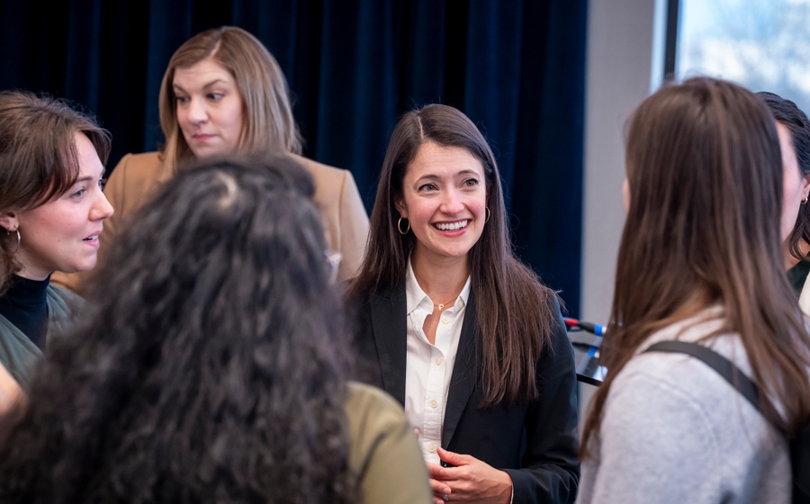 Members of event crowd socialize.