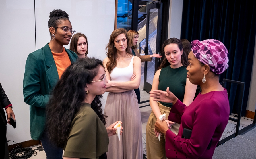 Members of event crowd socialize.