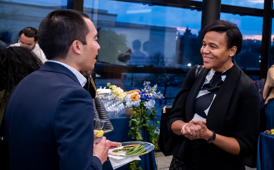 A woman smiles at a man during conversation.