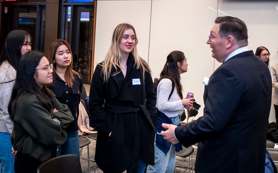 Members of event crowd socialize.