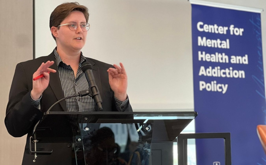 A woman standing behind a podium.