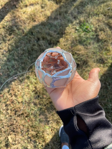 hand holding broken glass bowl art