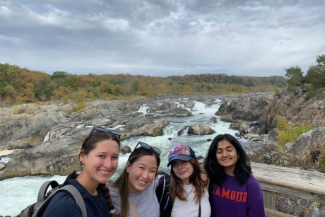 four young women posing in a natural environment