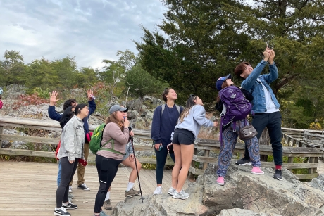 a group of students pose for a selfie in a natural environtment