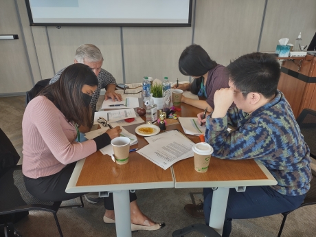 A group of IGTC staff work on an exercise together.