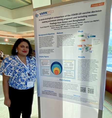 Prachi stands next to her post that she is presenting at VARN2023