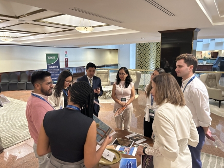 A group of people in a circle discussing their work